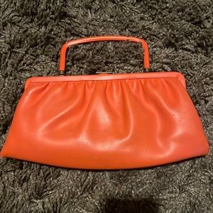 Vintage women’s orange clamshell clutch with optional folding handle